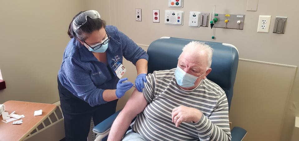 Daniel Poyant, a respiratory therapist at Morton Hospital in Taunton, receives his COVID-19 vaccine on Dec. 16, 2020.