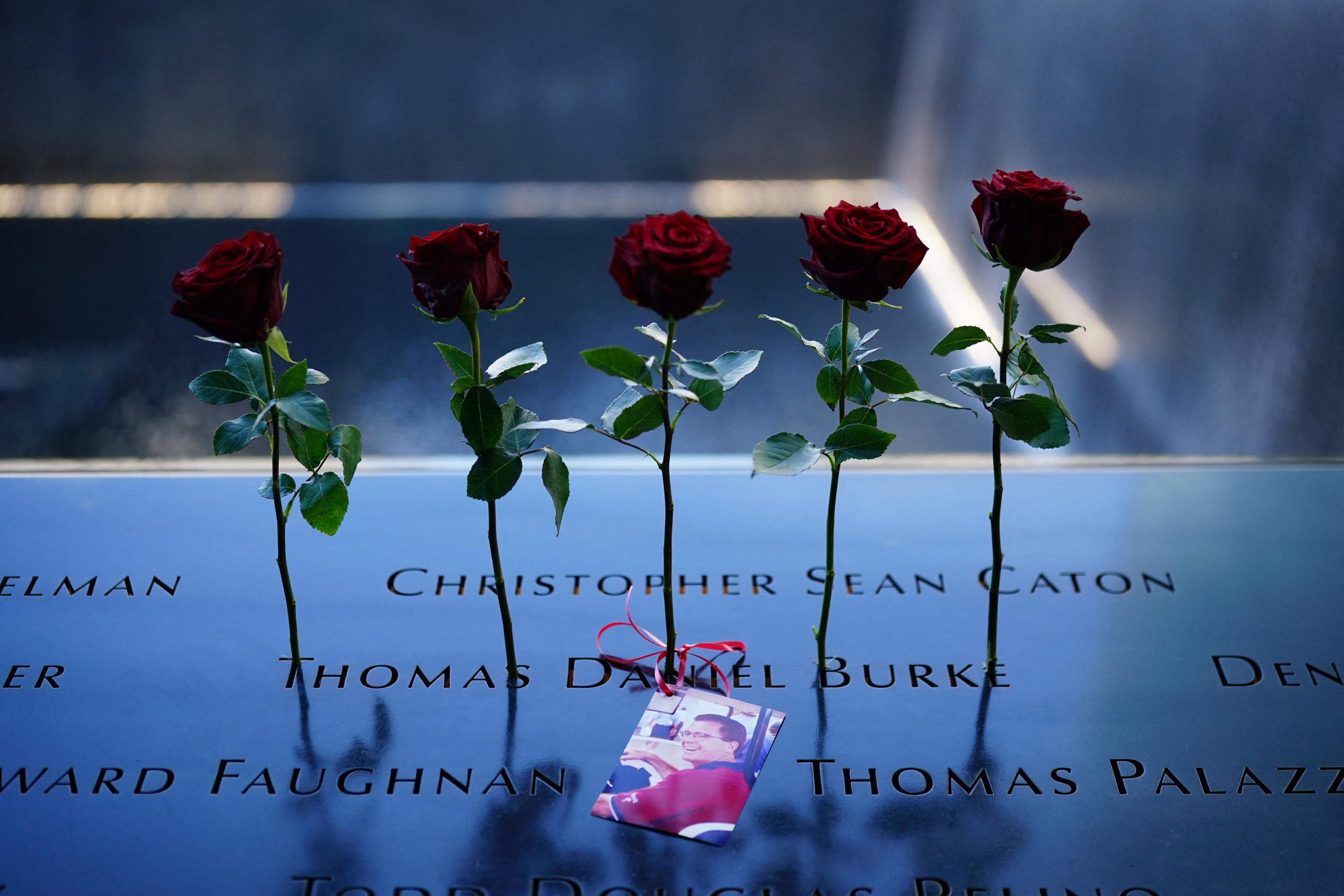 Roses lie next to the names of the victims in the North Tower Memorial Pool. 