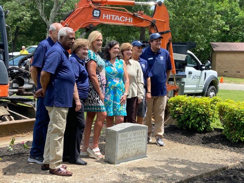 Members of the Bicentennial Commission pose for a picture with the marker of the time capsule before digging it up at Muse Park on Wednesday, June 1, 2022.