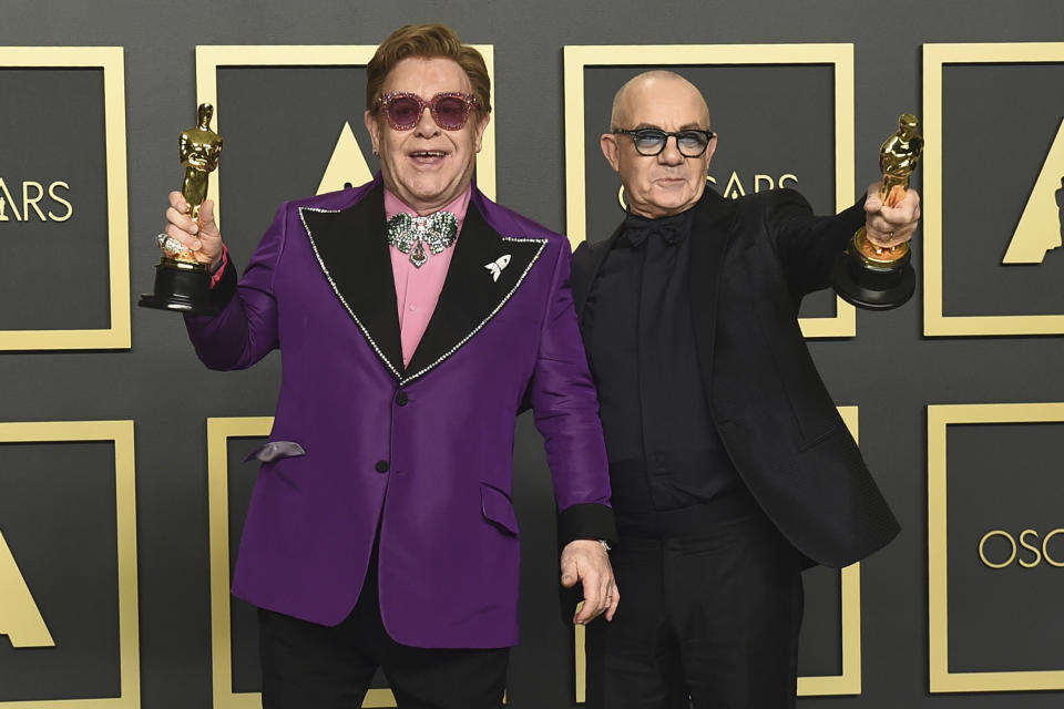 Elton John, left, and Bernie Taupin, winners of the award for best original song for "(I'm Gonna) Love Me Again" from "Rocketman", pose in the press room at the Oscars on Sunday, Feb. 9, 2020, at the Dolby Theatre in Los Angeles. (Photo by Jordan Strauss/Invision/AP)