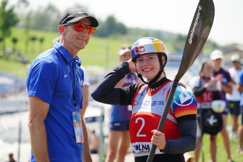 Evy Leibfarth smiles big with her dad and coach, Lee Leibfarth, at the International Canoe Federation’s 2023 Junior and Under 23 Canoe Slalom World Championships.
