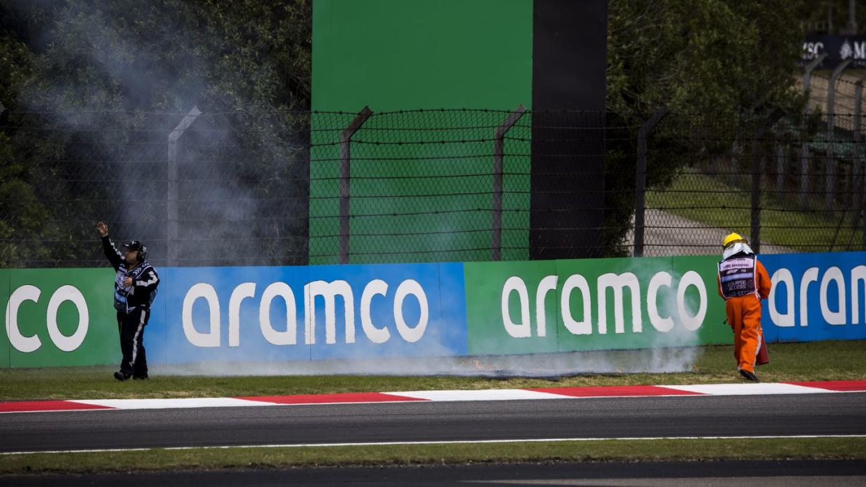 marshals rush to put out the fire on the grass during the formula 1 chinese grand prix in shanghai, china photo by sam bloxhammotorsport imagessipa usa france out, uk outsipa via ap images