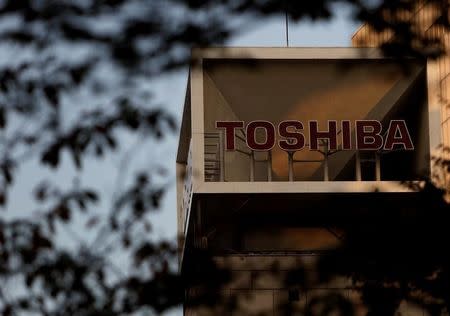 The logo of Toshiba Corp is seen behind trees at its headquarters in Tokyo, Japan, November 6, 2015. REUTERS/Yuya Shino/File Photo