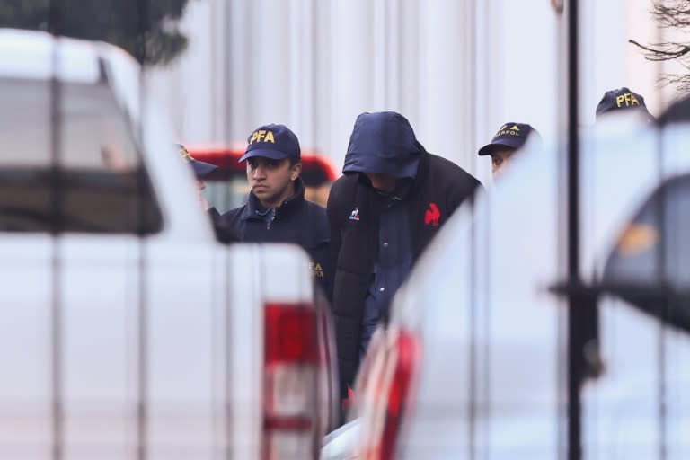 French national rugby player Oscar Jegou (C) is escorted by Argentinian federal police as he leaves the Interpol headquarters in Buenos Aires for the city of Mendoza on July 11, 2024 (STRINGER)