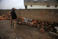 Members of the demining team stand beside bombs belonging to Islamic State militants in Khazer, Iraq December 1, 2016. Picture taken December 1, 2016. REUTERS/Khalid al Mousily