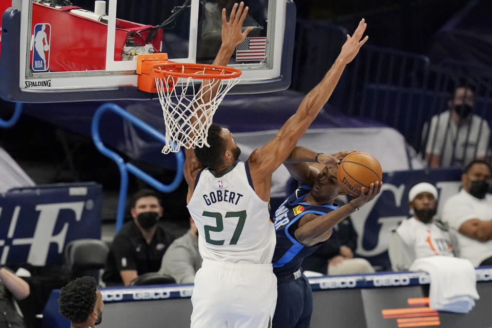 Oklahoma City Thunder forward Jaylen Hoard, right, looks to pass around Utah Jazz center Rudy Gobert (27) in the first half of an NBA basketball game Friday, May 14, 2021, in Oklahoma City. (AP Photo/Sue Ogrocki)