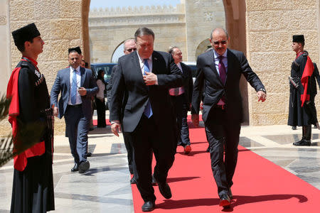 Jordanian Foreign Minister Ayman Safadi receives U.S. Secretary of State Mike Pompeo before meeting with Jordan's King Abdullah II at the Royal Palace in Amman, Jordan April 30, 2018. Khalil Mazraawi/Pool via Reuters