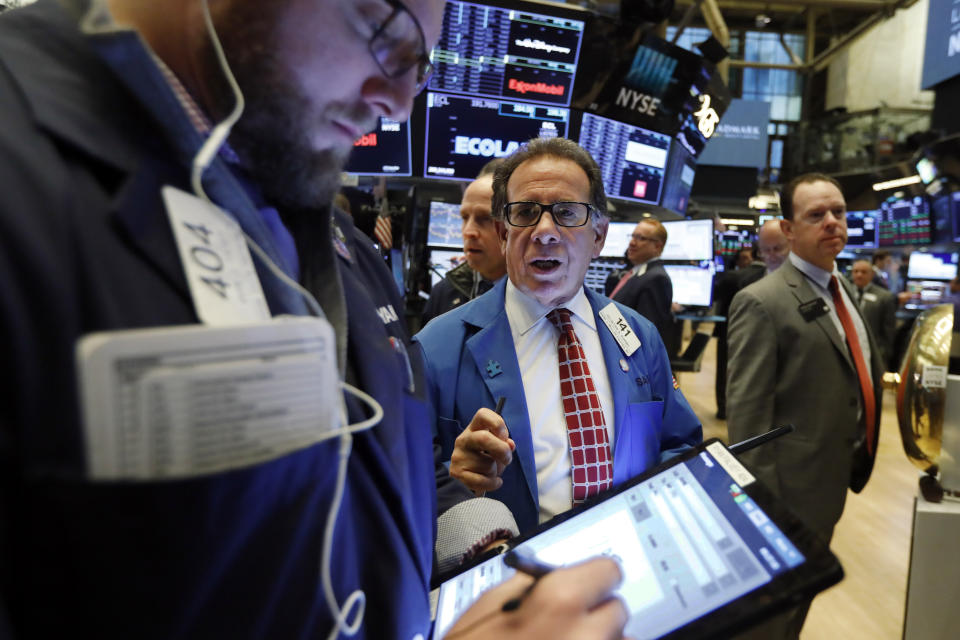 Sal Suarino, center, works with fellow traders on the floor of the New York Stock Exchange, Friday, Nov. 15, 2019. Stocks are opening broadly higher on Wall Street as hopes continued to grow that the U.S. and China were moving closer to a deal on trade. (AP Photo/Richard Drew)