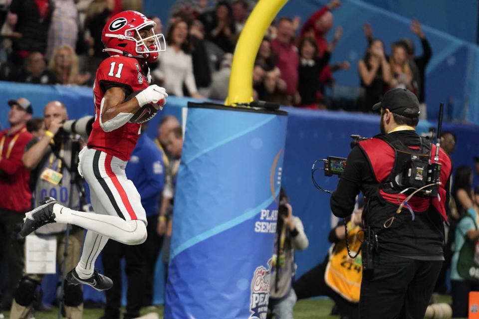 Georgia wide receiver Arian Smith (11) celebrates his touchdown against Ohio State during the second half of the Peach Bowl NCAA college football semifinal playoff game, Saturday, Dec. 31, 2022, in Atlanta. (AP Photo/Brynn Anderson)