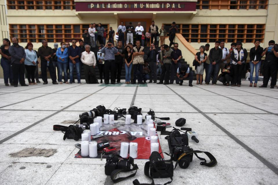 Local journalists stage a protest on the day that fellow journalist Gregorio Jimenez was buried after his body was discovered alongside the corpse of a union leader whose kidnapping was the topic of two of Jimenez's stories, in Coatzacoalcos, Mexico, Wednesday, Feb. 12, 2014. Veracruz state officials concluded that Jimenez, a police beat reporter, was killed in a personal vendetta, unrelated to his reporting. But journalists throughout Mexico are calling for a thorough investigation. Jimenez is the 12th journalist slain or gone missing since 2010 in the Gulf state of Veracruz. (AP Photo/Felix Marquez)