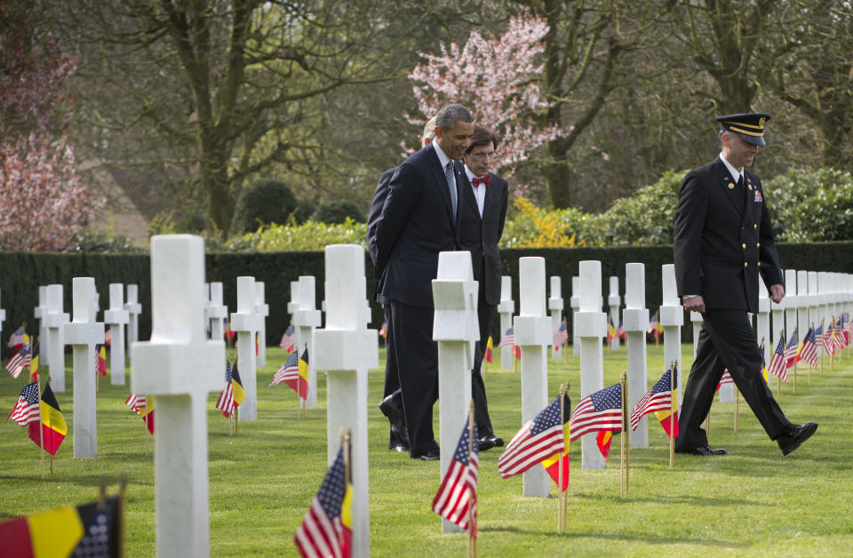 In this March 26, 2014, photo, President Barack Obama, center, walks through American cemetery at Flanders Field with Belgian King Phillipe, Belgian Prime Minister Elio Di Rupo, and Chris Arsenaeult, far right, Flanders Field Superintendent, in Waregem, Belgium. From the heart of Europe to the expanse of Saudi Arabia's desert, Obama's weeklong overseas trip amounted to a reassurance tour for stalwart, but sometimes skeptical, American allies. At a time when Obama is grappling with crises and conflict in both Europe and the Middle East, the four-country swing also served as a reminder that even those longtime partners still need some personal attention from the president. (AP Photo/Pablo Martinez Monsivais)