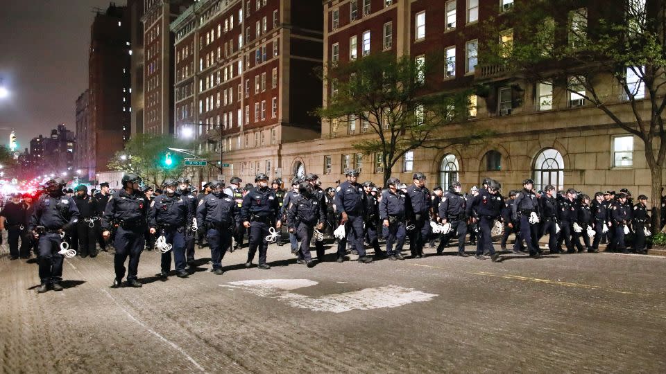 NYPD officers in riot gear march onto Columbia University campus, where pro-Palestinian students are barricaded inside a building and have set up an encampment, in New York City on April 30, 2024. - Kena Betancur/AFP/Getty Images