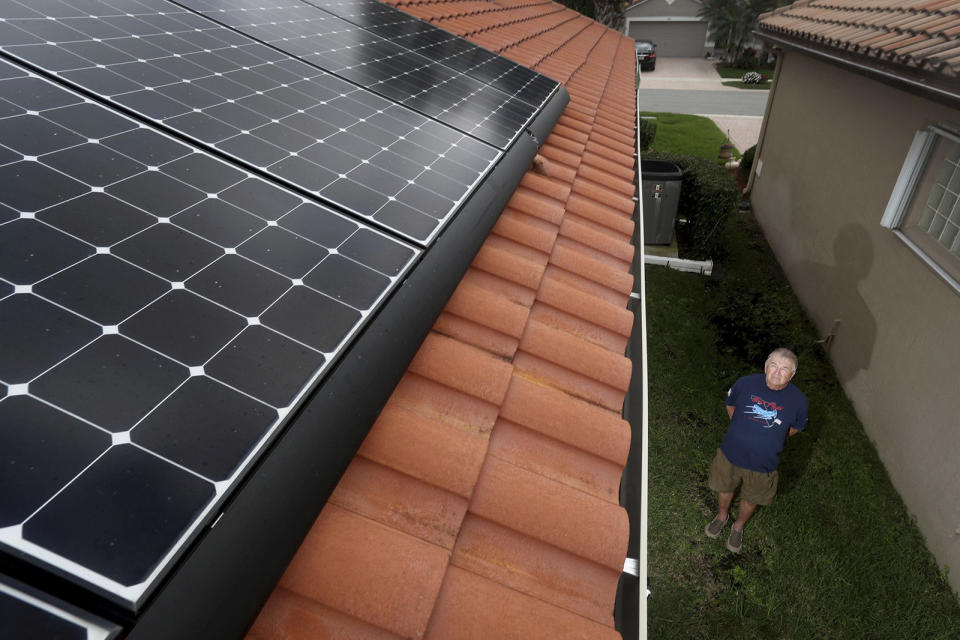 Boynton Beach resident Fred Closter shows off his $40,000 rooftop solar power system, which includes $24,000 in solar panels and two $8,000 Tesla storage batteries that enable Closter and his wife to live almost completely free of FPLs grid. Congress and the Biden Administration last week made it easier for other Floridians to achieve the same goal by increasing the 30% federal tax credit for solar systems through 2032. (Susan Stocker/Sun Sentinel/Tribune News Service via Getty Images)