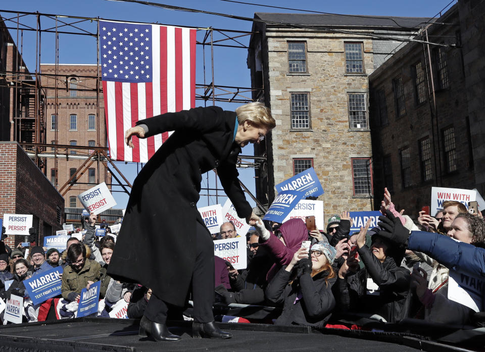 Sen. Elizabeth Warren, D-Mass., shakes hands with supporters as she takes the stage during an event to formally launch her presidential campaign, Saturday, Feb. 9, 2019, in Lawrence, Mass. (AP Photo/Elise Amendola)