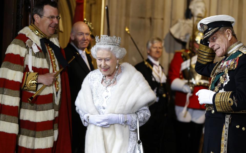 Britain's Queen Elizabeth II smiles with The Duke of Edinburgh, right, as they leave after the State Opening of Parliament, at the Houses of Parliament in London, Wednesday, May 8, 2013. The State Opening of Parliament marks the formal start of the parliamentary year, the Queen will deliver a speech which will set out the government's agenda for the coming year. (AP Photo/Kirsty Wigglesworth, Pool)