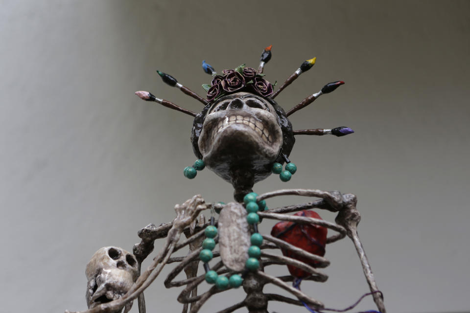 A skeleton sculpture depicting late Mexican artist Frida Kahlo stands on display at the Frida Kahlo museum in Mexico City, Tuesday, Oct. 2, 2012. A full collection from Kahlo's wardrobe will go on public display Nov. 22 in Mexico City after being locked for nearly 50 years in her armoires and dressers: jewelry, shoes and clothes that still carry the scent of the late artist's perfume and cigarette smoke or stains from painting. (AP Photo/Dario Lopez-Mills)