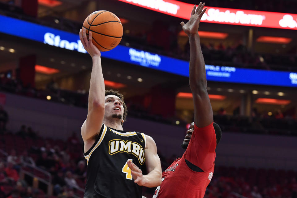 Maryland Baltimore County guard Marlon Short (4) shoots over the defense of Louisville forward Brandon Huntley-Hatfield (5) during the first half of an NCAA college basketball game in Louisville, Ky., Monday, Nov. 6, 2023. (AP Photo/Timothy D. Easley)