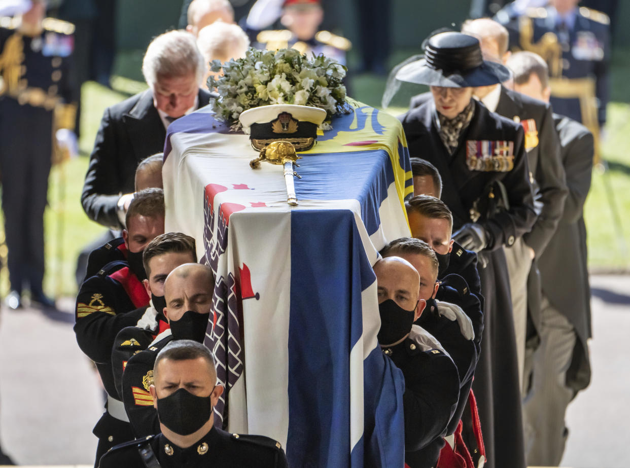 Pall Bearers carrying the coffin of the Duke of Edinburgh, followed by the Prince of Wales, left and Princess Anne, right, into St George's Chapel for his funeral, at Windsor Castle, in Windsor, England, Saturday April 17, 2021. Prince Philip died April 9 at the age of 99 after 73 years of marriage to Britain's Queen Elizabeth II. (Danny Lawson/Pool via AP)