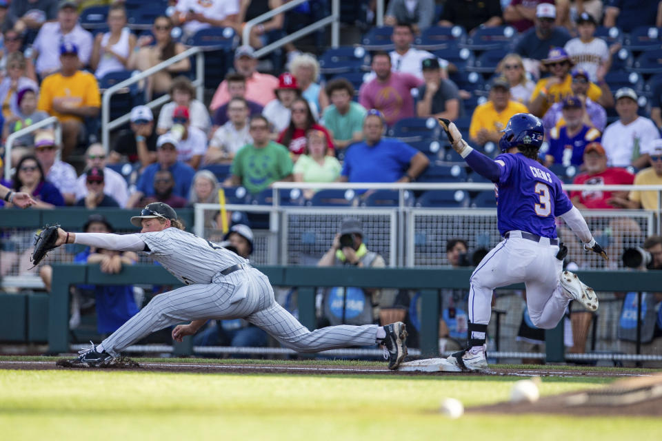 LSU's Dylan Crews (3) makes it to first base against Wake Forest first baseman Jack Winnay during the first inning in a baseball game at the NCAA College World Series in Omaha, Neb., Thursday, June 22, 2023. (AP Photo/John Peterson)