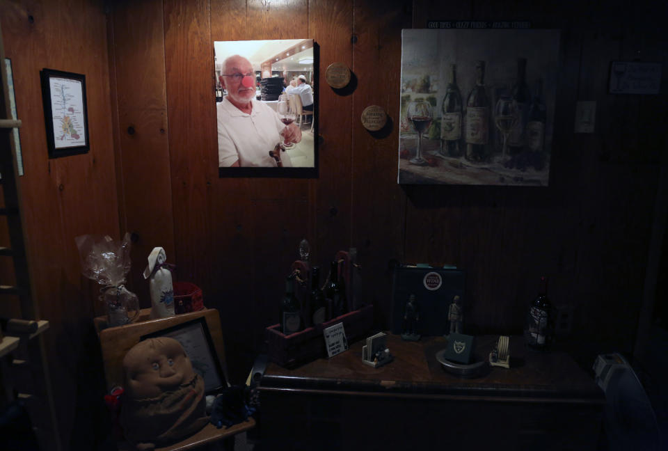 A portrait of the late John Walter wearing a red clown nose hangs in the basement of his family's home in the Queens borough of New York, Tuesday, March 30, 2021. Walter died of the coronavirus at Mount Sinai Hospital on May 10, 2020. (AP Photo/Jessie Wardarski)