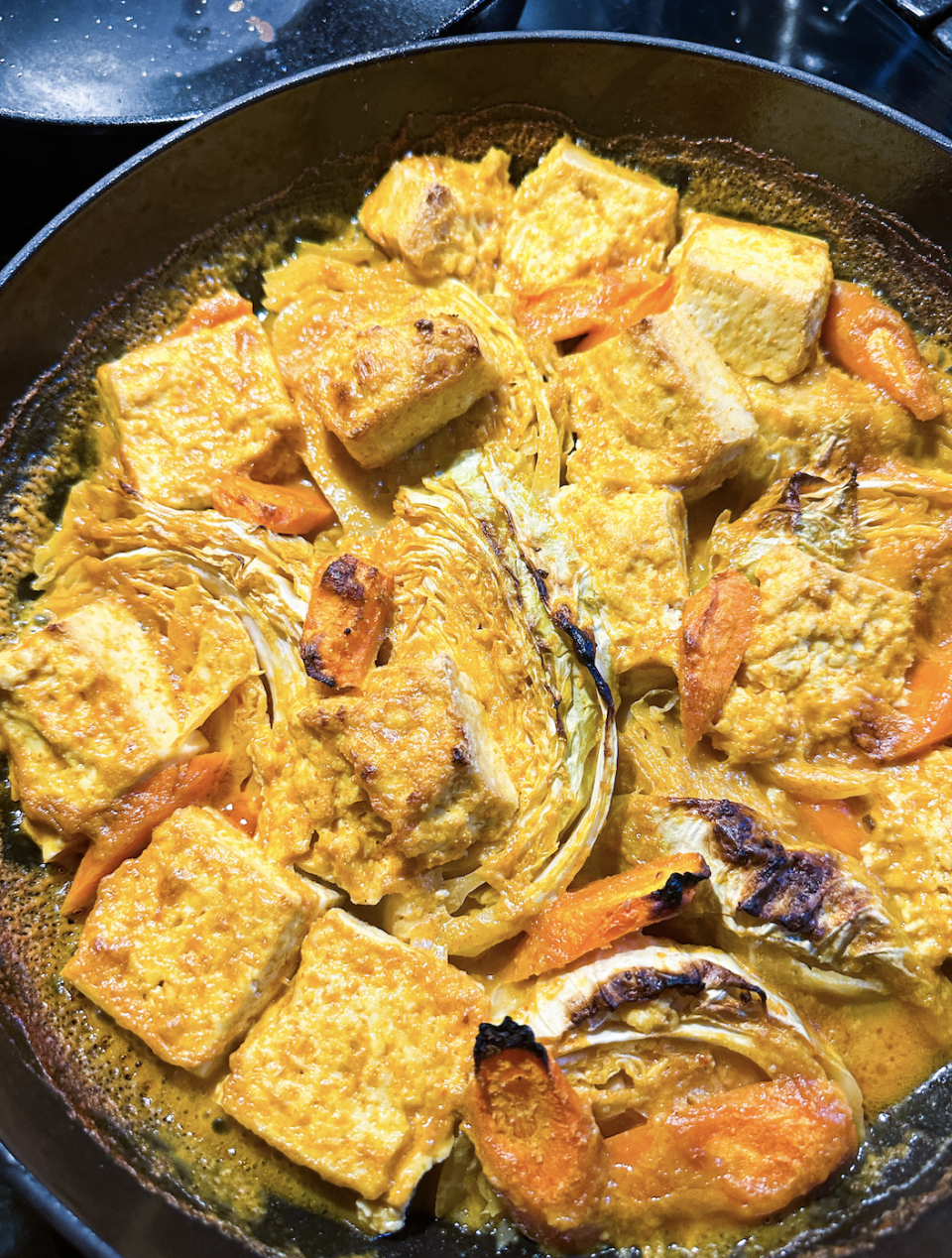 dish of caramelized tofu, cabbage, and carrots in a curry sauce