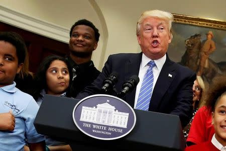 U.S. President Donald Trump is surrounded by local schoolchildren as he delivers remarks at a school choice event at the White House in Washington, U.S. May 3, 2017. REUTERS/Jonathan Ernst