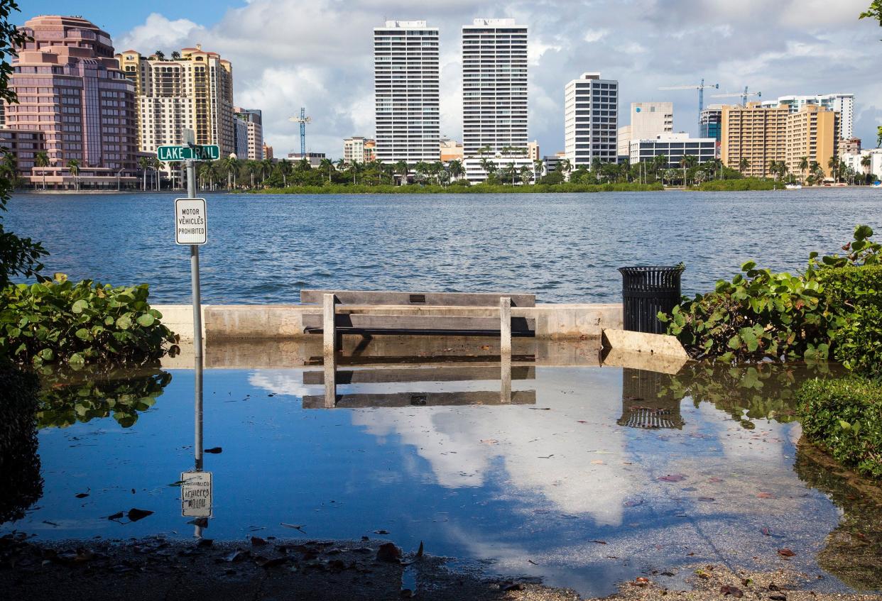 Water from the Intracoastal Waterway floods Lake Trail at Seaspray Avenue in Palm Beach at high tide. King Tides are becoming more noticeable in Palm Beach County thanks in part to climate change.