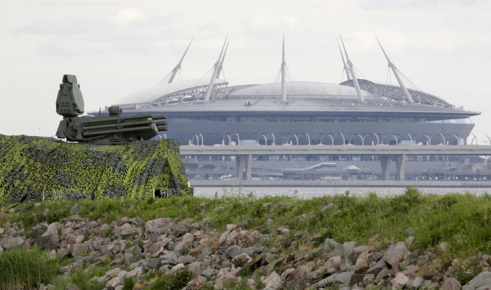 FILE - In this June 12, 2018, file photo, a Pantsir antiaircraft missile system, left, stands on guard of the air space above Saint Petersburg stadium which will host some 2018 World Cup matches in St.Petersburg, Russia. A year after hosting the World Cup, Russia is boasting the biggest club soccer crowds since Soviet days and participation at the amateur level is on the rise. Still, there are signs of trouble for the sport. (AP Photo/Dmitri Lovetsky, File)