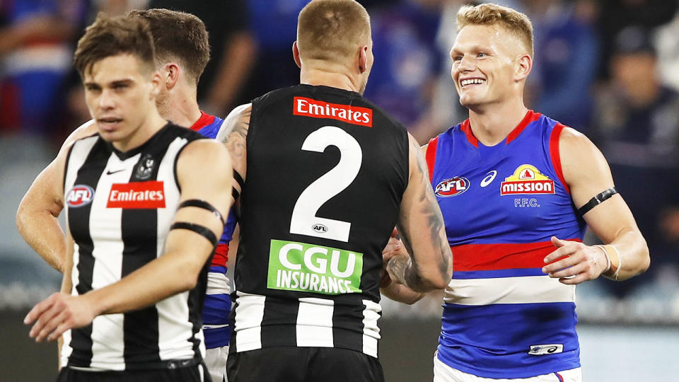 Adam Treloar, pictured here embracing his former teammates after the Western Bulldogs' win over Collingwood.