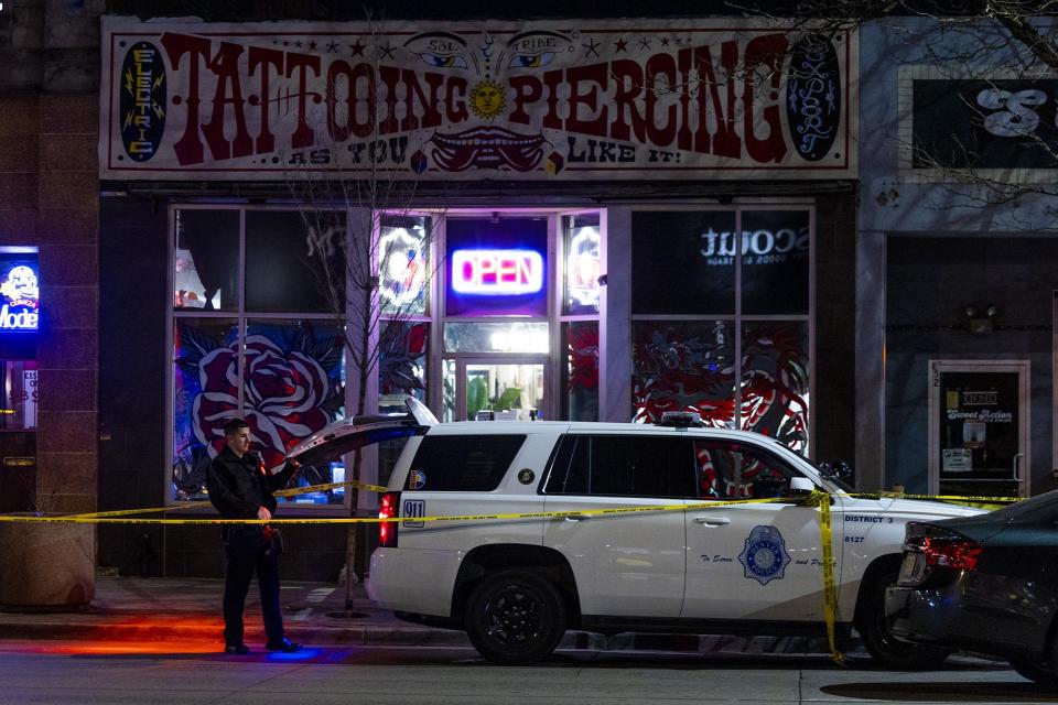 Police officers stand outside Sol Tribe tattoo shop the night Alicia Cardenas was murdered there. - Credit: Michael Ciaglo/Getty Images