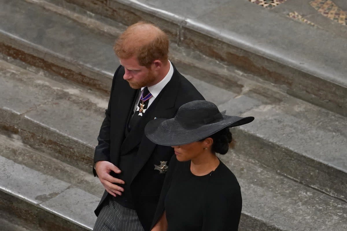 The Duke and Duchess of Sussex follow the bearer party with the coffin of Queen Elizabeth II (Gareth Fuller/PA) (PA Wire)