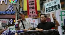 Lam Wing-kee (L), one of five Hong Kong booksellers who went missing last year, speaks at a protest in Hong Kong on June 18, 2016