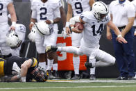 Iowa defensive back Jack Koerner (28) trips up Penn State quarterback Sean Clifford (14) on a run in the first half of an NCAA college football game, Saturday, Oct. 9, 2021, in Iowa City, Iowa. (AP Photo/Matthew Putney)