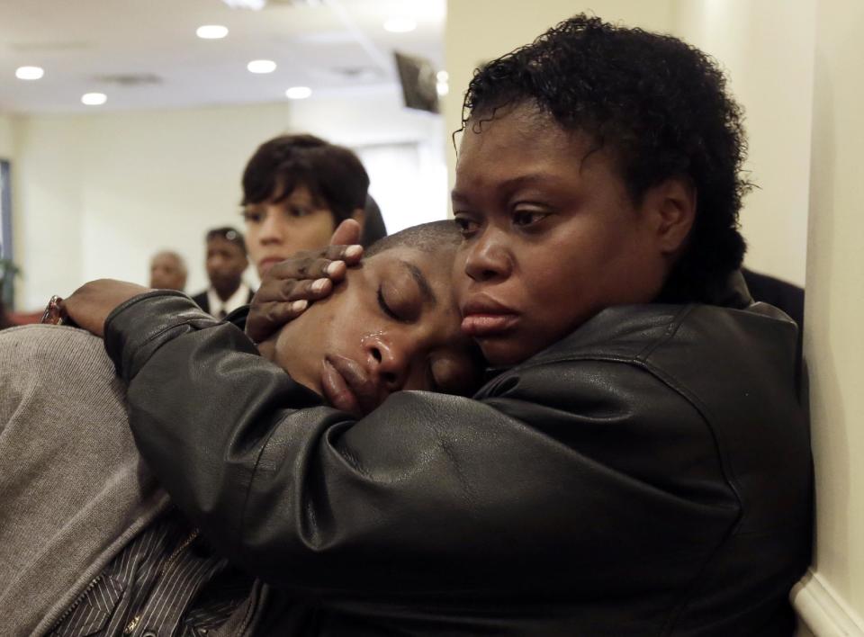 Lakisha Murdough, right, consoles her sister Victoria Murdough, both daughters of Jerome Murdough, during his funeral at the Cobbs Funeral Chapel, in the Queens borough of New York, Friday, April 25, 2014. A modest family funeral was held for 56-year-old Murdough, a homeless former Marine who was found dead more than two months ago in an overheated New York City jail cell. (AP Photo/Richard Drew)