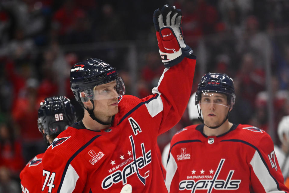 Washington Capitals defenseman John Carlson (74) acknowledges the crowd after setting a franchise record for a defenseman by scoring his 150th career goal, during the third period against the Tampa Bay Lightning in an NHL hockey game Saturday, April 13, 2024, in Washington. (AP Photo/John McDonnell)