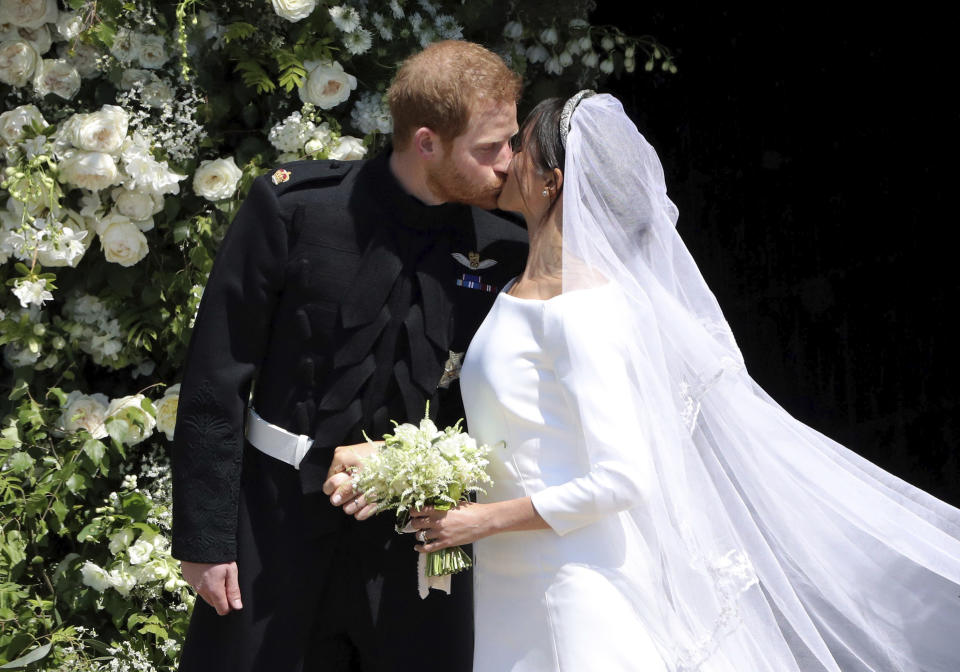 Britain’s Prince Harry and Meghan Markle share a kiss. Source: AP