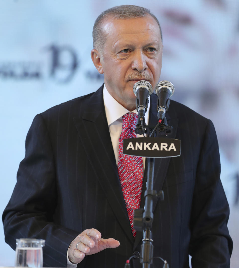 Turkey's President Recep Tayyip Erdogan addresses his party members, in Ankara, Turkey, late Thursday, Aug. 13, 2020. Erdogan warned of a "high price" to be paid for any attack on the Turkish search vessel Oruc Reis and even suggested that Turkey had already responded to an incident. (Turkish Presidency via AP, Pool)