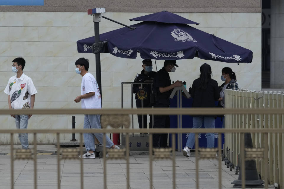 Security personnel screen visitors at a checkpoint leading towards the Tiananmen Square area in Beijing on Wednesday, June 2, 2021. Communist Party leaders have imprisoned or driven activists into exile and largely succeeded in ensuring young people know little about the June 4, 1989, deadly crackdown on the pro-democracy movement. But after three changes of leadership since then, they are relentless in trying to prevent any mention of the military attack that killed hundreds and possibly thousands of people. (AP Photo/Ng Han Guan)