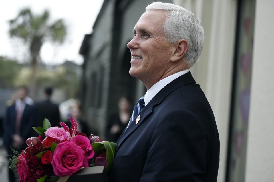 Vice President Mike Pence stops outside a flower shop after purchasing a Valentine's Day bouquet during a trip Thursday, Feb. 13, 2020, to Charleston, S.C. (AP Photo/Meg Kinnard