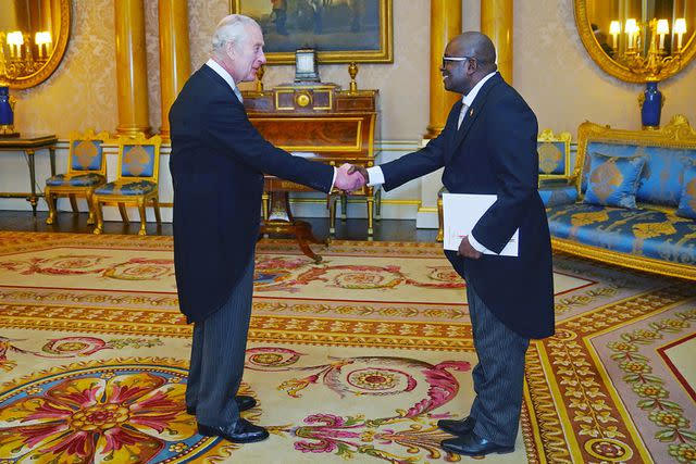 <p>Victoria Jones / POOL / AFP via Getty</p> King Charles greets the Ambassador of Burundi, Epimeni Bapfinda, at Buckingham Palace on March 28, 2024