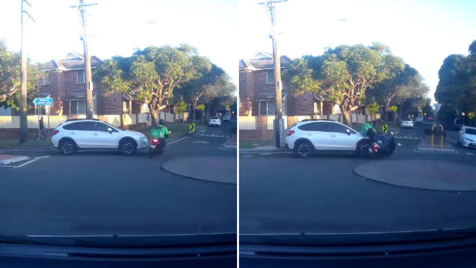 A delivery driver on a scooter in green enters the roundabout from the left and both vehicles collide resulting in the delivery driver being knocked off the scooter.