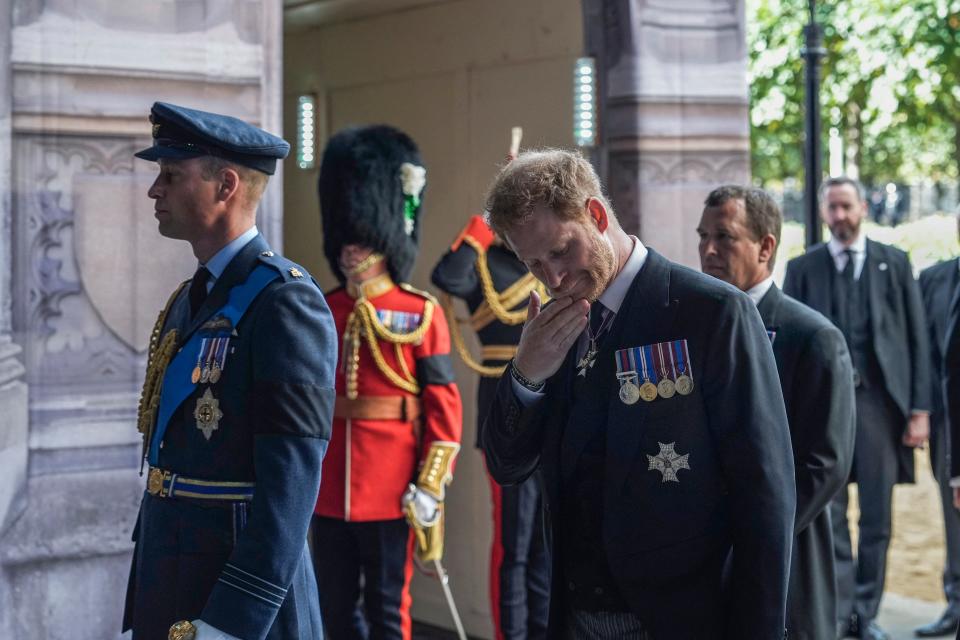 <p>Princes William and Harry look visibly emotional as they walk behind the coffin of Queen Elizabeth II ahead of her lying in state. (Getty)</p> 