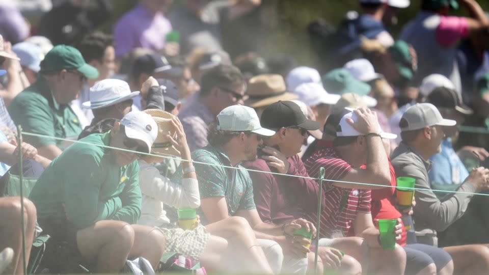 Sand whipped out from bunkers was a problem for players and fans alike. - Ashley Landis/AP