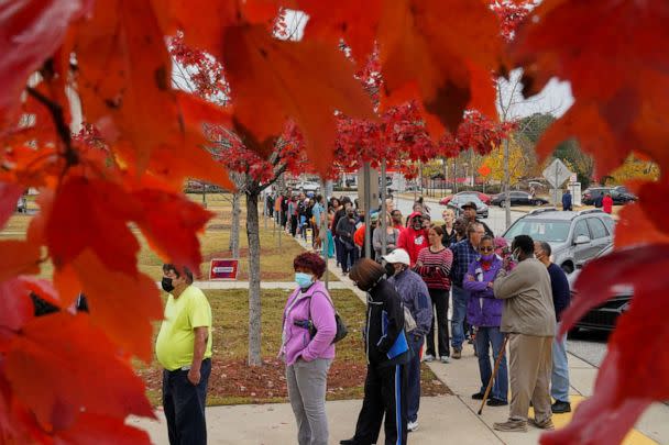 PHOTO: A line of early voters stretches outside the building at the start of early voting in the runoff U.S. Senate election between Warnock and his challenger Walker, at the City Services Center in Columbus, Muscogee County, Georgia, on Nov. 26, 2022.   (Cheney Orr/Reuters)