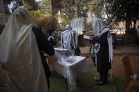 Ultra-Orthodox Jews keep social distancing during a morning prayer next to their houses as synagogues are limited to twenty people during a nationwide three-week lockdown to curb the spread of the coronavirus, in Bnei Brak, Israel, Thursday, Sept 24, 2020. Israel moved to further tighten its second countrywide lockdown as coronavirus cases continued to soar. The Cabinet voted to close all nonessential businesses, including open-air markets. Prayers and political demonstrations would be limited to open spaces and no more than 20 people, and participants would not be able to travel more than a kilometer (0.6 miles) from home for either. (AP Photo/Oded Balilty)