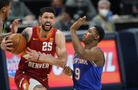 Denver Nuggets guard Austin Rivers, left, drives to the rim as New York Knicks guard RJ Barrett defends in the first half of an NBA basketball game Wednesday, May 5, 2021, in Denver. (AP Photo/David Zalubowski)