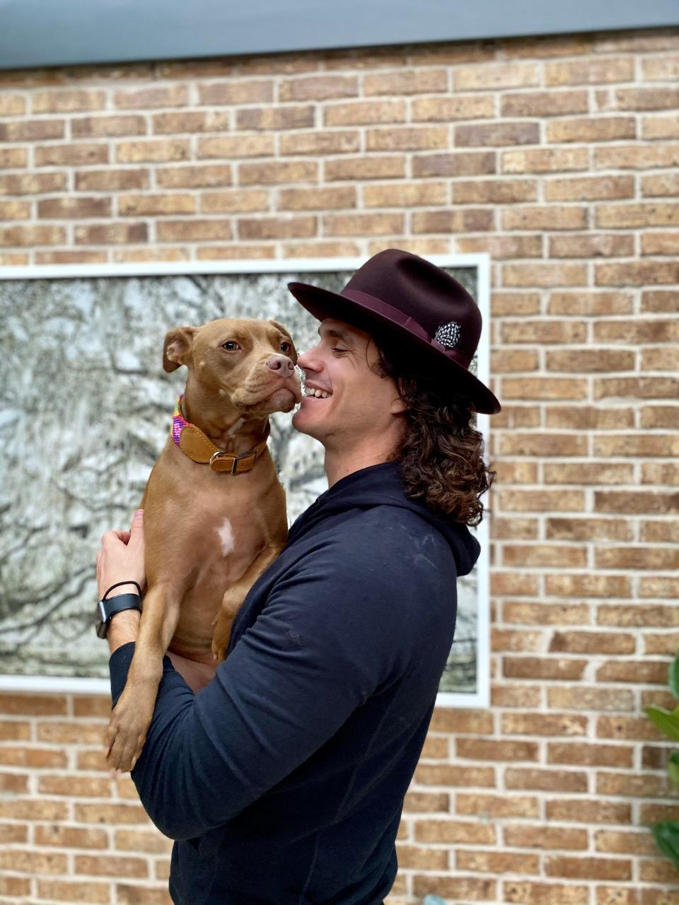 Former Jacksonville Jaguars kicker Josh Lambo is pictured in his renovated (and recently sold) Beauclerc Bluff home with his pup, Indie. Lambo adopted the mixed-breed dog in 2020 through Fur Sisters, a Jacksonville Beach rescue shelter.