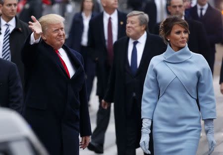 U.S. President Donald Trump and first lady Melania Trump walk along Pennsylvania Avenue during the inaugural parade from the U.S. Capitol in Washington, U.S., January 20, 2017. REUTERS/Jonathan Ernst