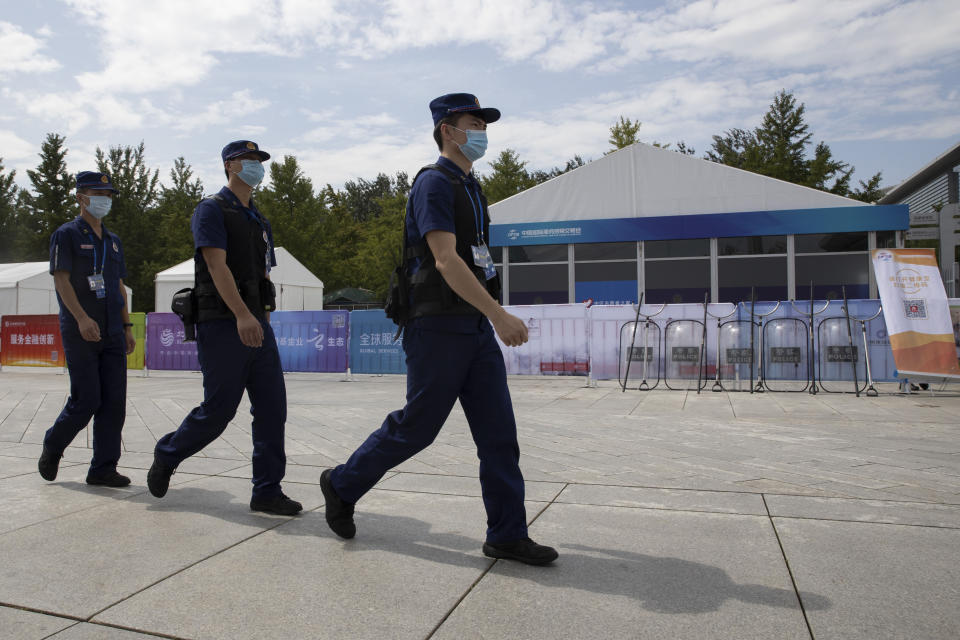 Security guards past near a checkpoint to the China International Fair for Trade in Services (CIFTIS) to be held in Beijing on Friday, Sept. 4, 2020. As China recovers from the COVID-19 pandemic, business as usual is picking back up with the holding of the China International Fair for Trade in Services. Nearly 2,000 Chinese and foreign enterprises will participate and showcase their newest technology in public health and digital technology (AP Photo/Ng Han Guan)
