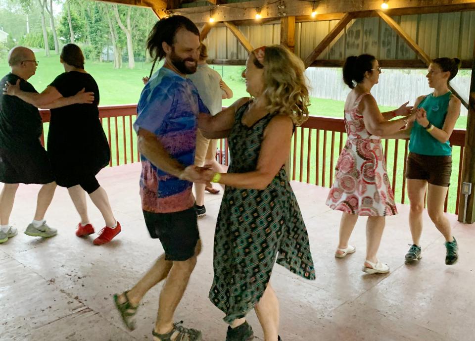 Dancers of all ages and skill levels are welcome to participate in the contra dances hosted by the Bloomington Old-Time Music and Dance Group. Most dances are in Harmony School's gym. This August 2021 dance was outdoors.